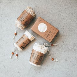 A set of reusable market bags made from natural materials like jute and cotton. The bags feature a simple, minimalist design with neutral tones and natural textures.