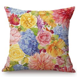 Colorful floral cushion with vibrant blooms including roses, dahlias, and hydrangeas in shades of pink, yellow, and blue.