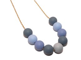Colorful beaded necklace with round pastel-colored beads in shades of blue, green, and yellow on a gold-tone chain.