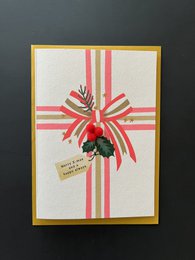 A Christmas card with a red bow and pine branch design, featuring the text "Merry Xmas and a happy always".