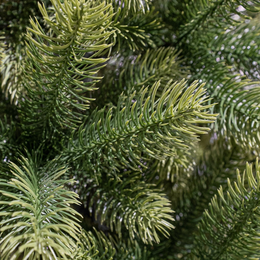 Tall, full, green artificial Christmas tree with realistic pine needles and branches. Suitable for indoor or outdoor use.