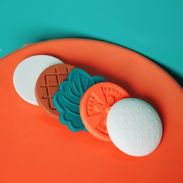  Colorful silicone stackable burger toy with orange, white, teal, red layers for babies and toddlers.