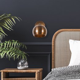  A round, wooden wall lamp with a warm, natural finish. The lamp features a simple, minimalist design that would complement a variety of interior styles.