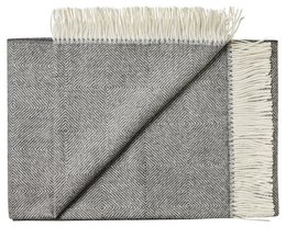 Soft, cozy throw blanket in a diamond pattern with a neutral color palette. Made from high-quality baby alpaca wool for a luxurious feel.