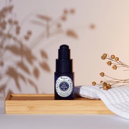 Polar Night Revitalizing Elixir is a face serum with a dark blue bottle and dropper. The serum appears to be a clear liquid. The product is designed to revitalize and nourish the skin.