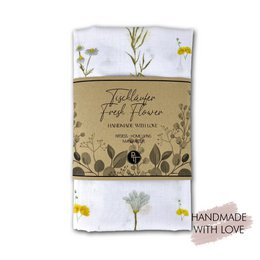 A rectangular table runner featuring a pattern of fresh yellow and white flowers on a white background. The runner is 145cm long and 45cm wide.