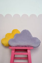 Soft, plush velvet pillow in a soothing purple color, perfect for adding a cozy touch to a baby's room. Decorative cloud-shaped accent pillow.