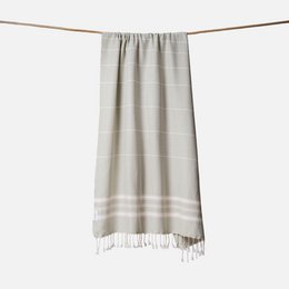 Beige striped hammam towel with fringe trim, lightweight linen cotton blend, traditional Turkish style.