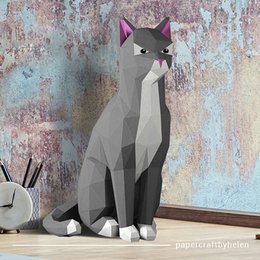 A gray geometric cat figurine with triangular shapes and a pointed ear. The cat has a simple, minimalist design and appears to be a DIY craft kit.