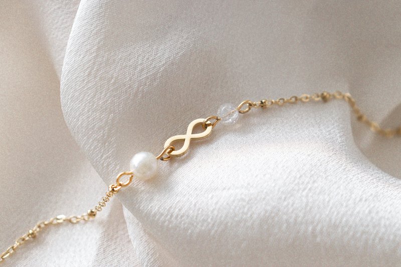 Infinity & Parel Armband - Goud