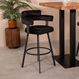 Black velvet bar stool with curved backrest, metal legs, modern swivel design, counter height seating.