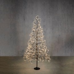  Illuminated Christmas tree, warm white lights, tall narrow conical shape, indoor decoration