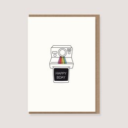 Folding card with envelope featuring a Polaroid-style illustration and the text "Happy Birthday". The card is suitable for birthday celebrations.