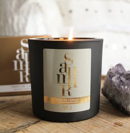 Black candle with gold text "SAUMUR" on the label, made of soy wax and scented.