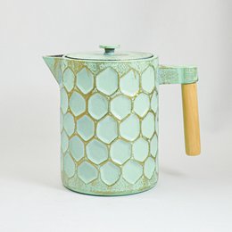 A mint green cast iron teapot with a gold honeycomb pattern, capable of holding 1.2 liters of liquid.