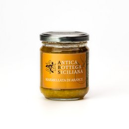 Sicilian orange jam in a glass jar with a yellow and black label. The jam appears to be a rich, golden color.