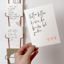 A handwritten postcard with the text "Kaffee, Kaffee, Kuchen, die Barista hot gerufen." The postcard appears to be a friendship card for a barista.