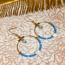 Gold brass clover earrings with Japanese resin pattern, available in rose, turquoise, and noir marron colors. The earrings feature a unique and stylish design with a touch of elegance.