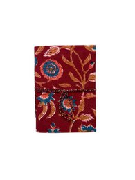 A6 sized notebook with a sustainable, floral-patterned cover in shades of red, blue, and orange.