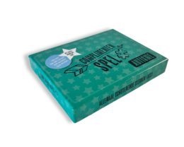A game box with a teal background, featuring a star and the text "Compliment Game Autism REVISED". The game appears to be designed for individuals with autism, focused on providing compliments.