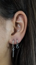Silver zircon pendant with a round, sparkling stone. Elegant and minimalist drop earrings.