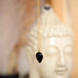  Black onyx pendant necklace with a gold chain.
