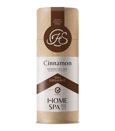 Organic cinnamon essential oil in a brown glass bottle with a natural paper label. The oil is labeled as "Cinnamon" and part of the "Home Spa" line.
