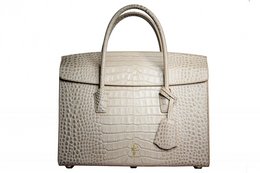 Stylish beige leather laptop bag with crocodile-embossed texture, gold-tone hardware, and two top handles for convenient carrying.