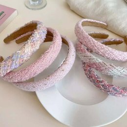 Stylish pink and white hairbands with glitter accents, perfect for adding a touch of sparkle to any hairstyle.