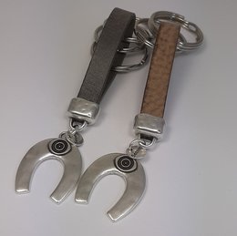 Vintage-inspired leather keychain with a lucky horseshoe charm, available in grey and brown colors.