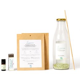 A 3L detergent box in a clear glass bottle with a yellow cap. The box is made of cardboard and has a label with product information.