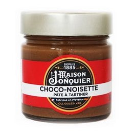 Homemade chocolate-hazelnut and honey-walnut spreads in jars. Smooth, creamy texture with rich, nutty flavors.