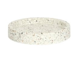 Oval-shaped terrazzo jewelry tray with a speckled white and gray pattern.