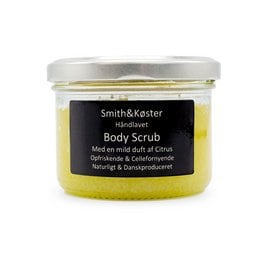 Citrus-scented body scrub in a glass jar. Made with natural ingredients including citrus oils for exfoliating and moisturizing skin.