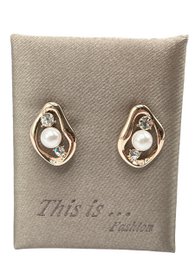 Elegant hoop earrings with a modern, minimalist design featuring a pearl-like accent. Crafted with a silver-toned metal for a sleek, sophisticated look.