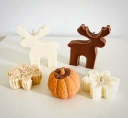  Handcrafted reindeer-shaped candles in a variety of colors including white, brown, beige, pink, red, green, blue, gray, purple, and orange. Pillar candle style with a unique and festive design.