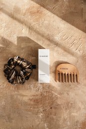 Hair oil gift set with scrunchie and wooden comb. Includes natural ingredients for healthy hair.