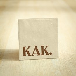 Beige square tile with the text "KAK" printed in brown.