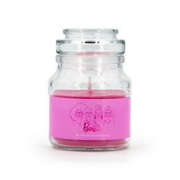 A pink-colored, round glass candle jar with the Barbie logo printed on the side. The candle appears to be a fragrance candle with a floral or fruity scent.
