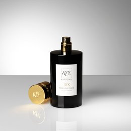 A luxurious, rose-scented perfume in a sleek black bottle with gold accents, packaged in a minimalist white box.
