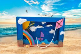 Craft package with nature-inspired beach scene, including colorful kites, clouds, and a sun against a blue sky backdrop.