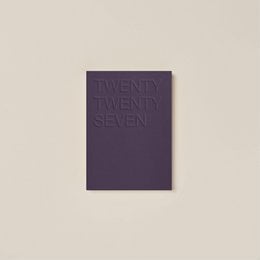 A dark brown journal with the text "TWENTY TWENTY SIX" embossed on the cover.