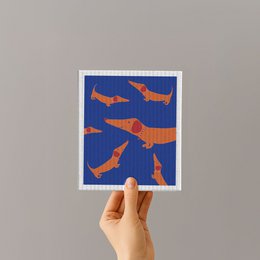 Dachshund-patterned kitchen sponge in blue and orange colors.