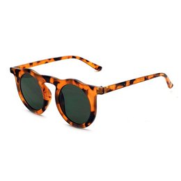 Round tortoiseshell sunglasses with dark green lenses. Stylish and retro-inspired design.