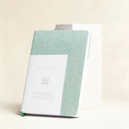 A5 hardcover notebook with blank pages, made of linen material in a cream color with a gold foil number 7 design on the cover.