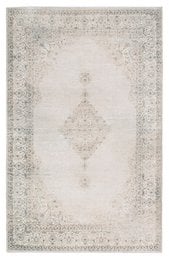 A large, vintage-style area rug with a modern, short pile. The rug features a neutral sand color and a detailed, intricate pattern. It is machine washable for easy care.