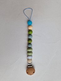 Pacifier clip with glow-in-the-dark blue bead and colorful beads in a gradient pattern.