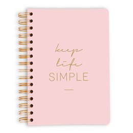 A simple, pink spiral-bound notebook with the text "Keep Life Simple" printed on the cover.