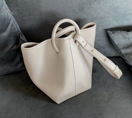 Beige leather shoulder bag with dual handles, suitable for everyday use.