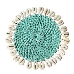Rattan coaster with cowrie shells